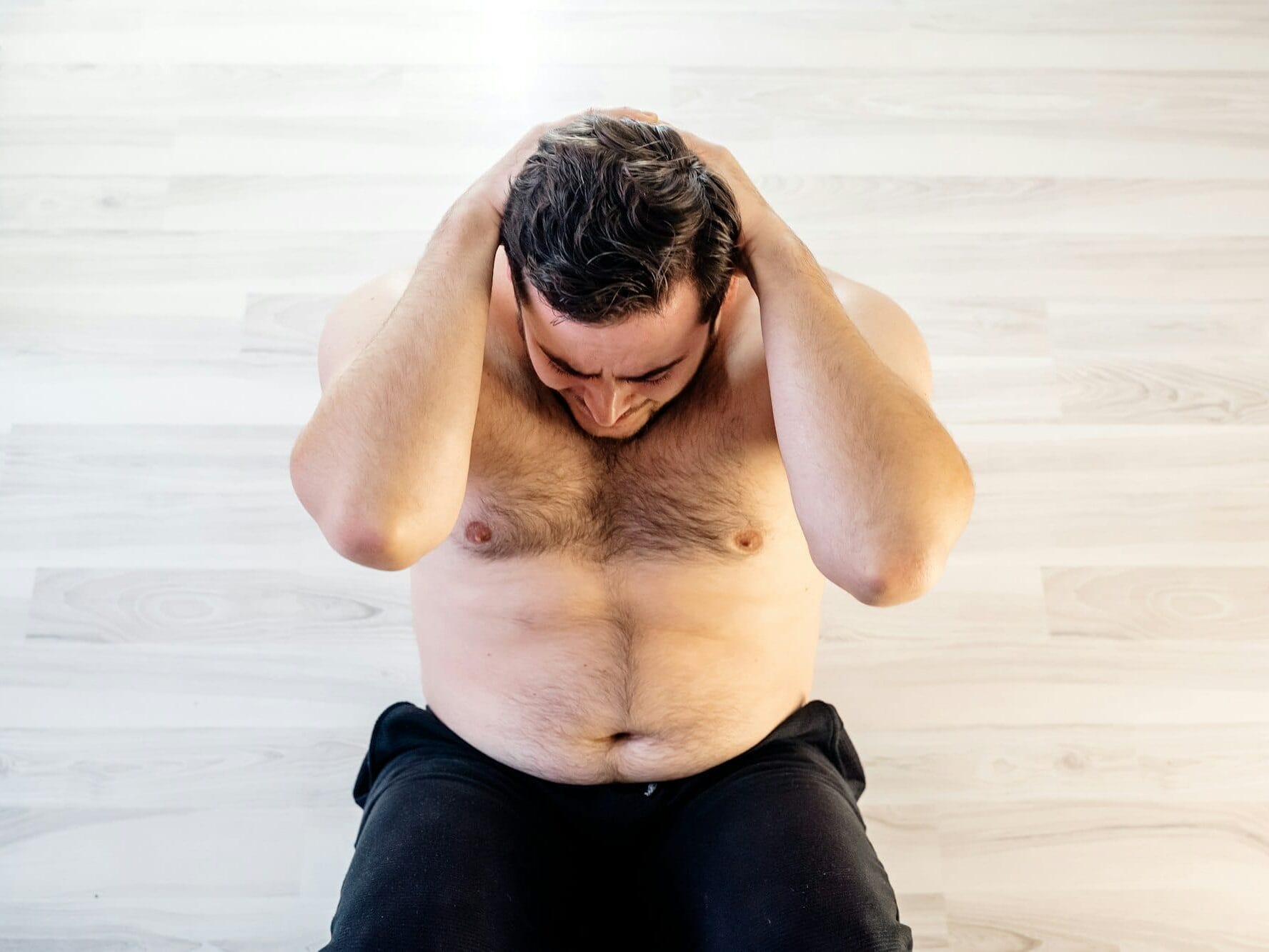 Overweight person man doing exercise to weight loss at home.