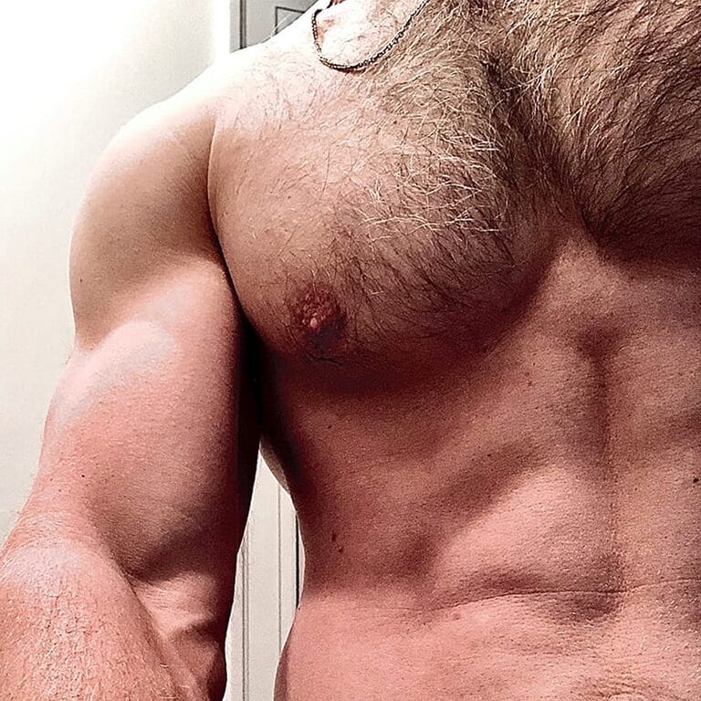Close up on a bare chest with bicep flexed